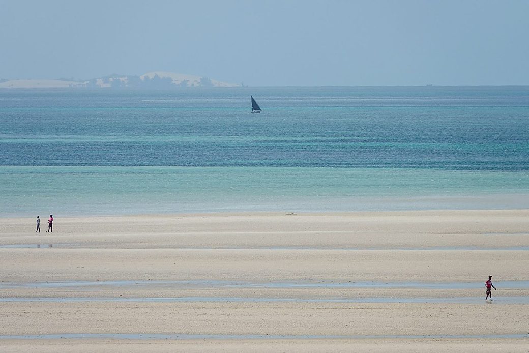 A dhow on a turquoise sandbank in the ocean