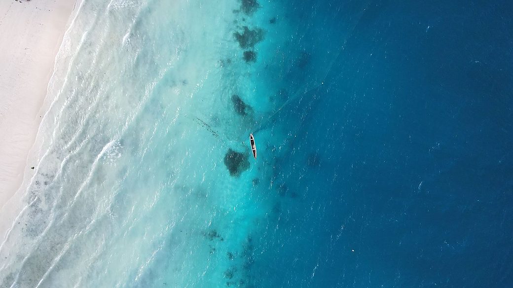 Aerial view of a turquoise Zanzibar beach and reef