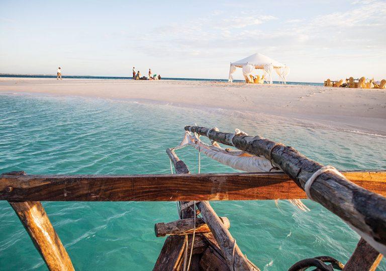 A dhow moored at the Nakupenda sandbank, a strip of white sand in a turquoise sea